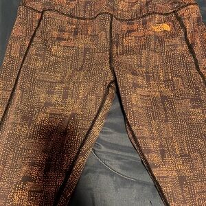 The North Face Orange and Black Patterned Apparel